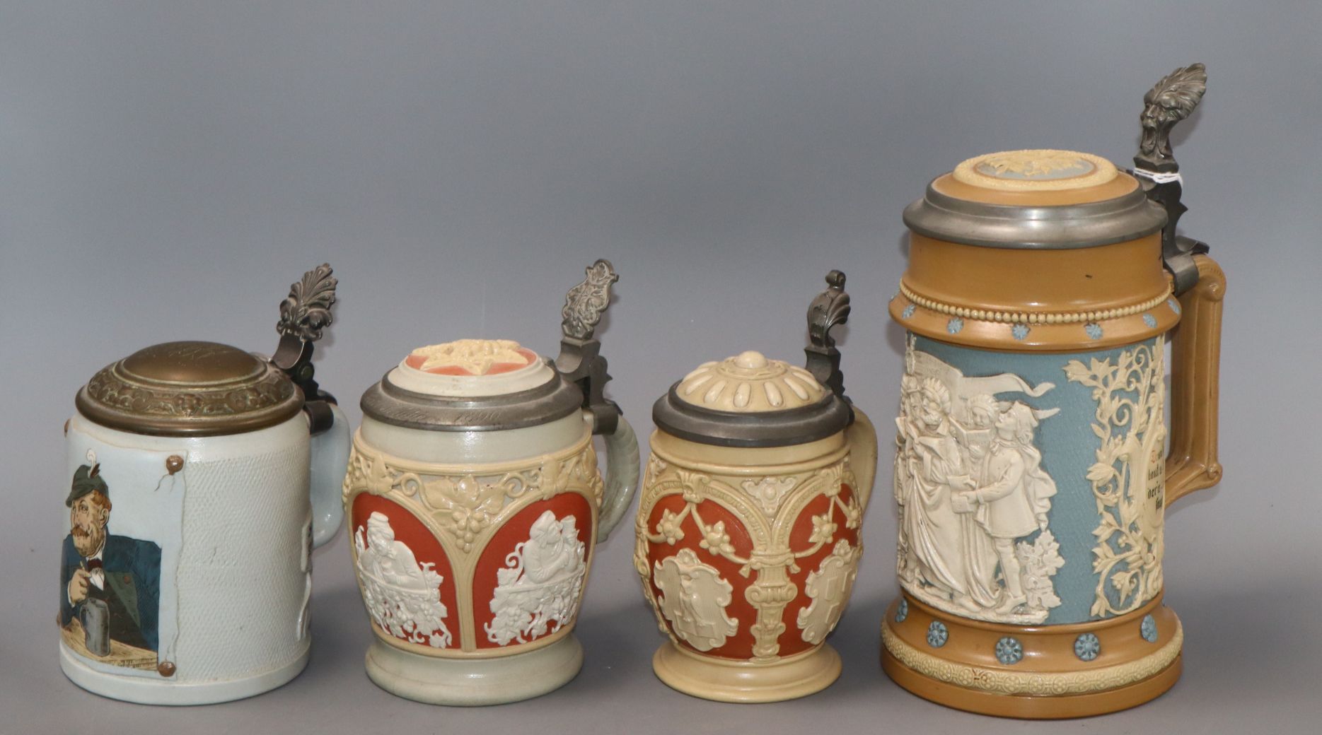 A Mettlach stein decorated with singers and three others