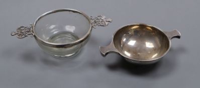 An Indian white metal quaich by Cooke & Kelvey, and a white metal mounted glass quaich(a.f.),