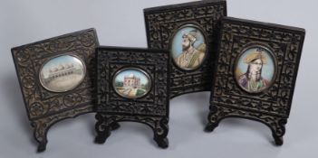 A pair of Indian oval painted miniatures of lady and gentleman in carved frames and two others