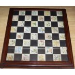 An early 20th century mahogany framed chess board, painted in watercolour with botanical studies