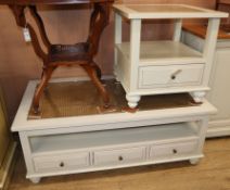 A pale green painted two tier plate glass topped coffee table, fitted two drawers and a matching