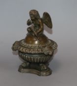 A 19th century French 'Grand Tour' bronze inkwell, the cover surmounted by a seated Cupid, lifting