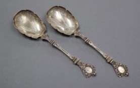 A pair of Victorian ornate silver serving spoons, by Charles Edwards, London, 1880, 24cm, 7 oz.