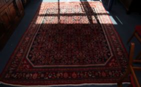 A Hamadan black ground small carpet 222 x 300cm