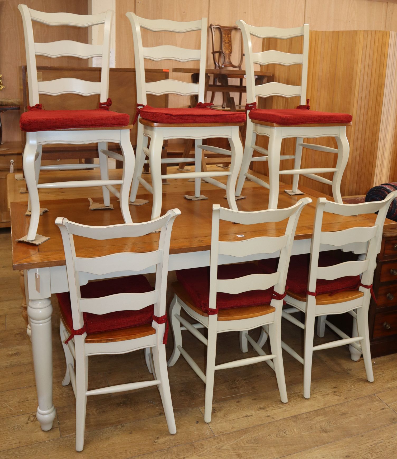 A pale green painted pine topped kitchen table, with six matching French style dining chairs (7)
