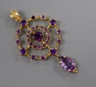 A 1970's Edwardian style 9ct gold and amethyst set openwork drop pendant, overall 55mm.