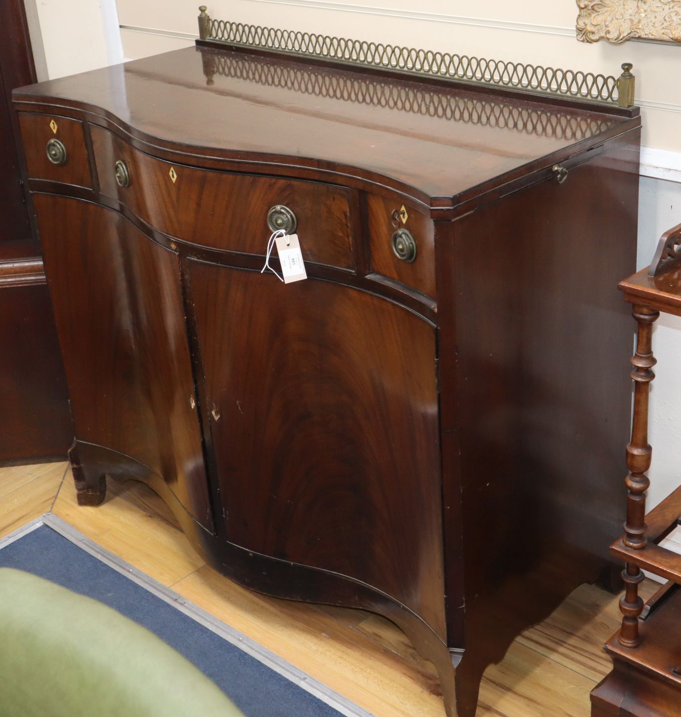 A George III style mahogany serpentine side cabinet W.108cm