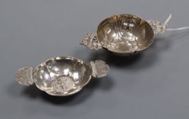 Two small 19th century continental white metal quaichs (repair), largest 9.9cm.