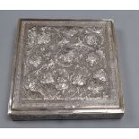 A Far Eastern white metal square box with embossed decoration of cranes and flowers