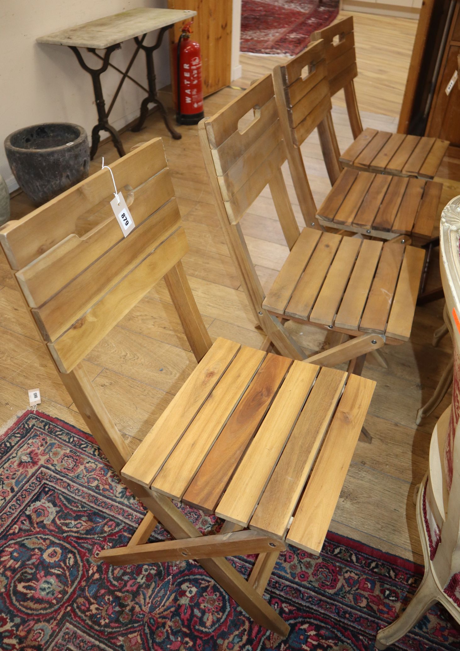 A set of four teak folding garden chairs