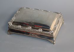 An Edwardian cigarette box, with pierced cast border and engraved top, marks rubbed, 20.3cm.