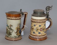A Mettlach jug decorated with dancers and a stein with floral decoration tallest 20cm