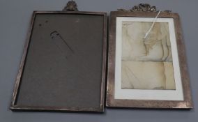 Two early 20th century silver mounted photograph frames, London, 1905 and 1911, both with surmounts,