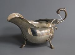 An Edwardian silver sauceboat with flying scroll handled, Walker & Hall, Sheffield, 1908, 8.5 oz.