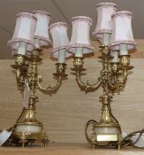 A pair of four branch gilt metal lamps
