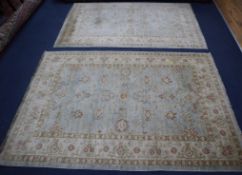 Two blue and cream Pakistan rugs 195 x 128cm and 200 x 143cm