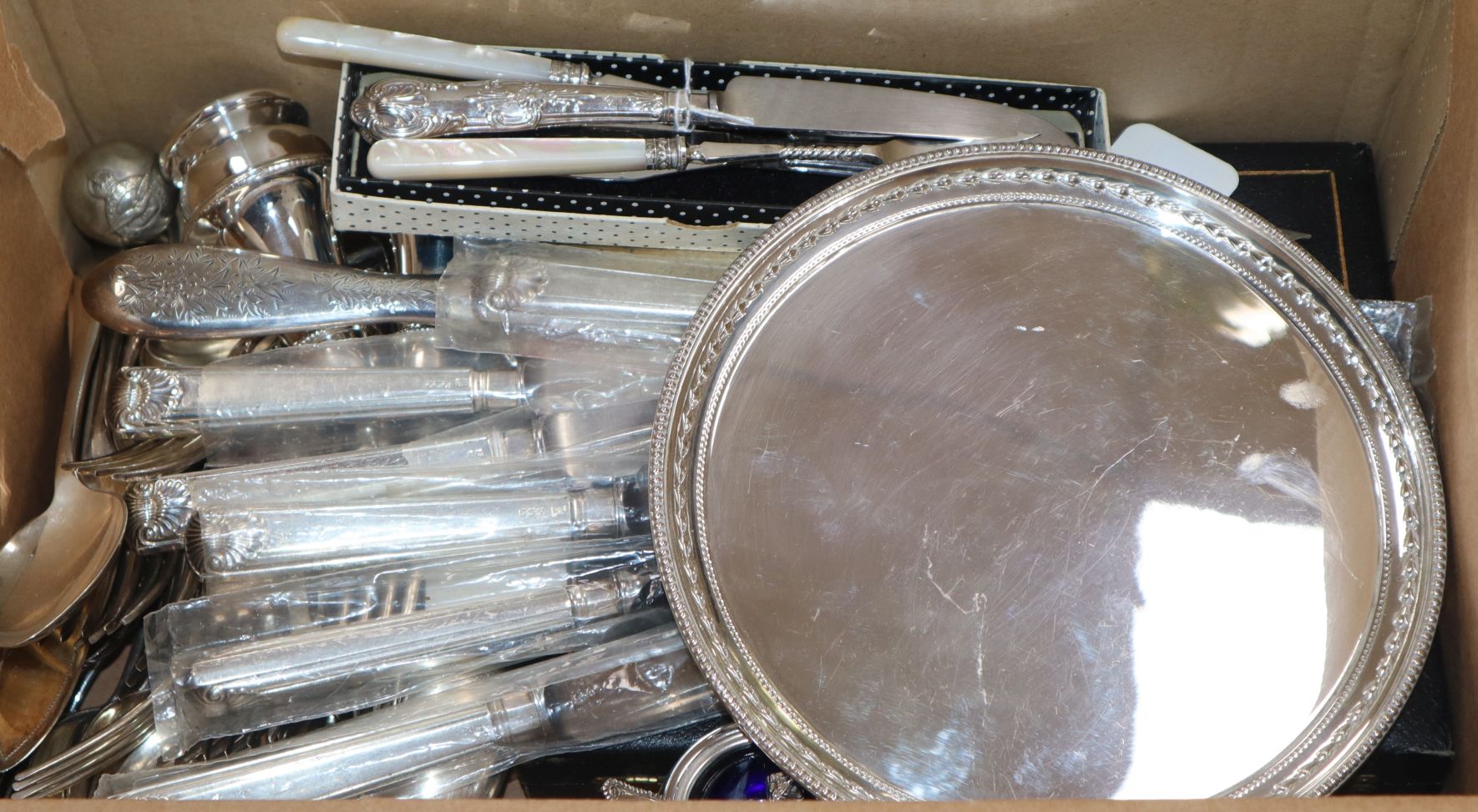 Silver-handled flatware, including a set of six dinner knives, a silver-backed hand mirror and