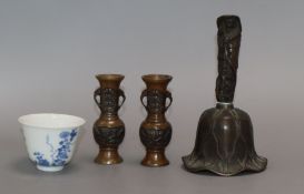 A Chinese bronze bell, a pair of miniature bronze vases and a blue and white cup with Kangxi mark