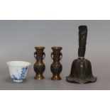 A Chinese bronze bell, a pair of miniature bronze vases and a blue and white cup with Kangxi mark