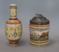 A Mettlach vase with floral decoration and a biscuit jar decorated with cattle