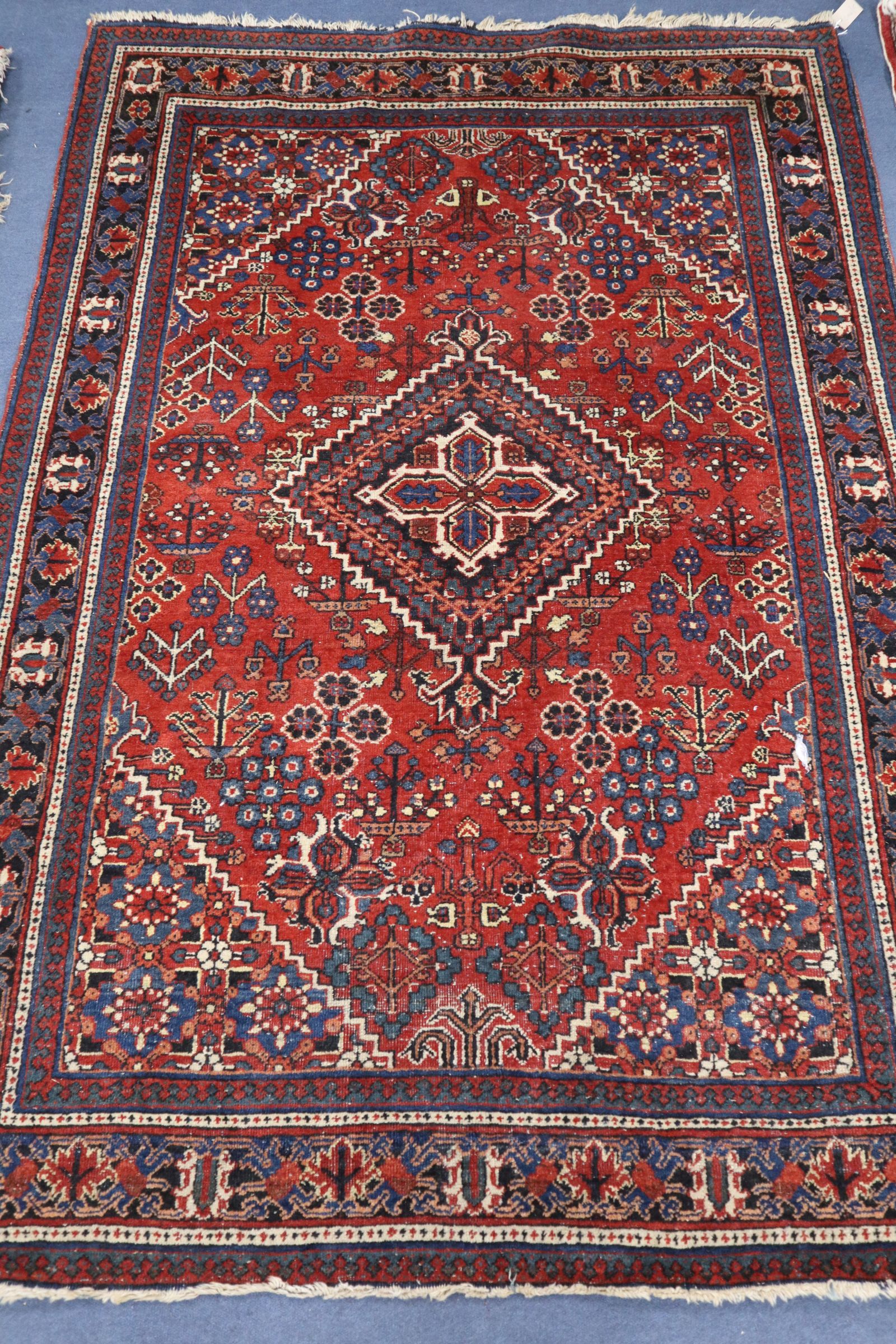 A North West Persian brick red ground rug 202 x 139cm