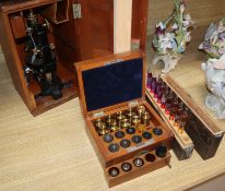 A 1920's Carl Zeiss Jena stereoscope microscope and two boxes of lenses and a chemical tester