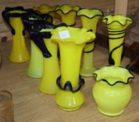 Nine yellow glass vases