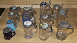 Thirteen glass steins with pewter lids