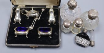 A 1920's cased five piece silver condiment set, five silver mounted scent/toilet bottles and one