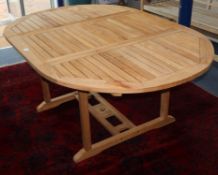 An extending teak garden table L.180cm