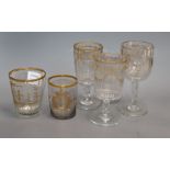 Three 19th century German gilt glass goblets and a similar tumbler