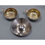 A pair of continental white metal taste vin, with gilt interior, embossed with berries and a