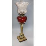 A Corinthian column brass oil lamp with shades