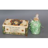 A Crown Devon musical box and pin cushion doll