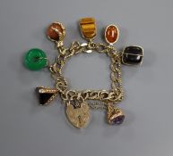 A 9ct gold charm bracelet with padlock clasp and seven assorted charms