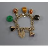 A 9ct gold charm bracelet with padlock clasp and seven assorted charms