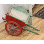 A small painted wood animal with iron spoked wheels