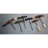 Six 19th century English steel and wood handled corkscrews, five with turned rosewood handles and