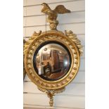 A Regency design giltwood convex wall mirror, with eagle surmount W.82cm