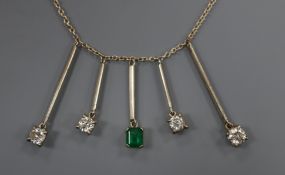 An 18ct white gold multiple drop necklace, set with an emerald and four diamonds
