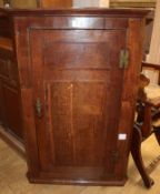 A George III oak hanging corner cupboard W.79cm