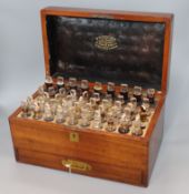 A Victorian mahogany apothecary chest, by W.H. Auckland, from E. Gould and Sons, with 47 bottles and