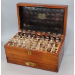 A Victorian mahogany apothecary chest, by W.H. Auckland, from E. Gould and Sons, with 47 bottles and