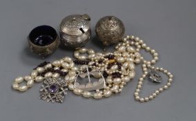 An Indian white metal three piece condiment set, three silver Scottish brooches, a garnet necklace