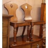 A pair of Victorian mahogany hall chairs