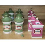 A set of six green and gilt ceramic drug jars and covers and a set of four pink and gilt ditto