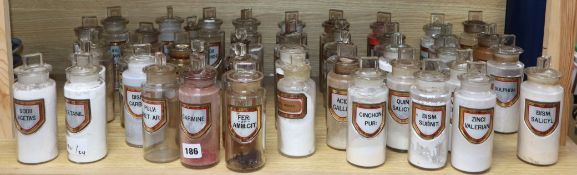 A collection of forty four late Victorian chemist's dry drug jars and stoppers, with gilt framed