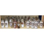 A collection of forty four late Victorian chemist's dry drug jars and stoppers, with gilt framed