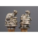 A pair of Victorian silver plated bottle stoppers modelled with recumbent panthers, 9cm