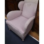 A pair of 1930's club style wing armchairs on silvered feet